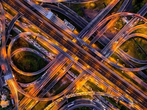 An aerial view of a complex motorway interchange at night